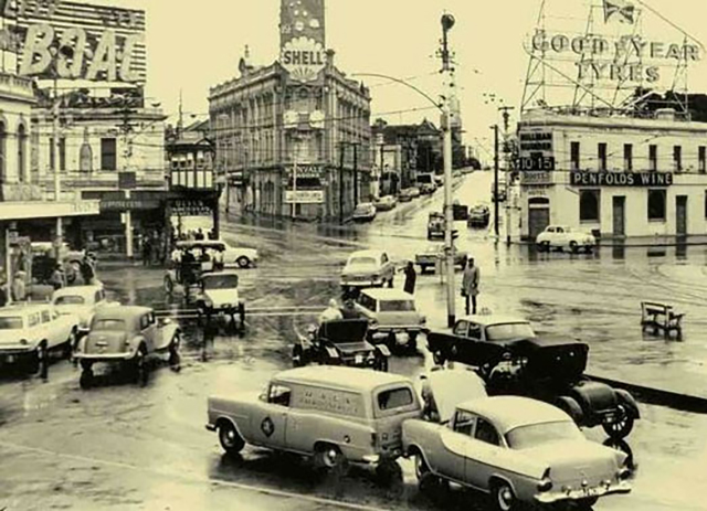 Traffic accident and traffic jostling through the roundabout at St Kilda Junction 1962
